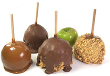 Load image into Gallery viewer, This is a picture of the 4 types of caramel apples that we offer at The Confectionary.  From left to right is a Caramel Apple, a Chocolate Caramel Apple, a Chocolate Peanut and Caraeml Apple and a Caramel Peanut Apple.  In the background there is a green Granny Smith apple so that customers can see which type of apple we use.