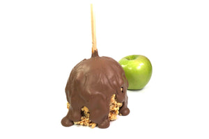 This is a caramel apple with nuts and covered in milk chocolate.  There is also a Granny Smith apple in the background.