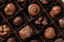 Load image into Gallery viewer, Top view of a box of chocolates.  There are  a mix of Milk &amp; dark chocolate buttercreams, as well as salted caramel and acorns, which are peanut butter and chocolate